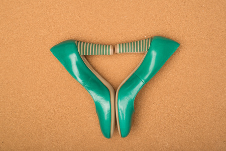 green high heels shoes on brown backgroundの写真素材