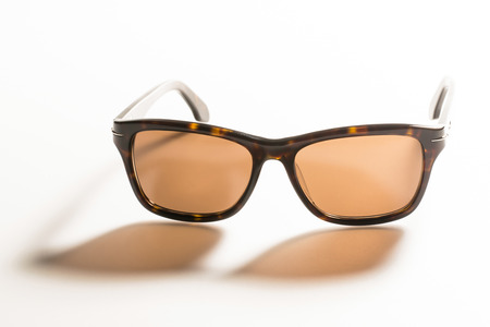 sunglasses on white background with long shadowの写真素材