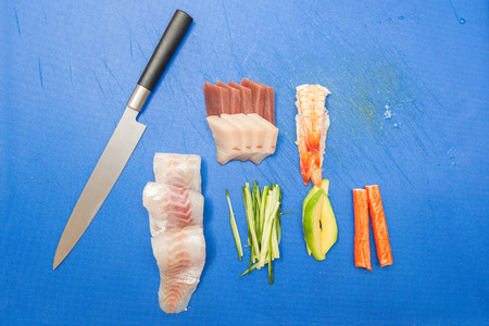 Japanese seafood ready for sushi on blue chopped board