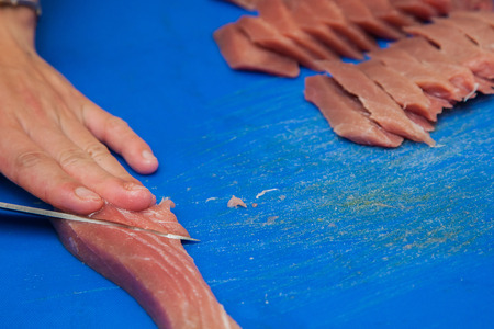 cutting tuna steak, fish raw preparingの写真素材