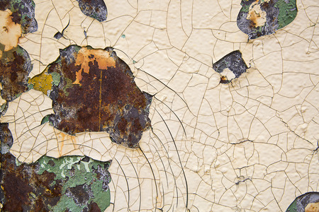 A rusty old metal plate with cracked white gloss paintの写真素材