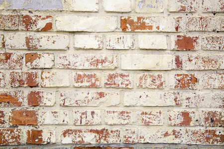 Background of old vintage dirty brick wall with peeling plaster, texture
