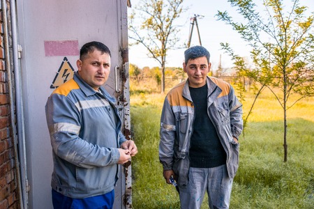 Electricians on high voltage substationの写真素材