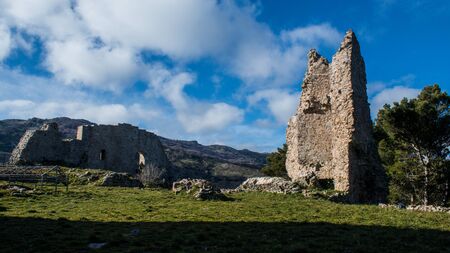 Ruins of the Old Ventimiglia Castle in Geraci Sicula with blue sky and cloudsの写真素材