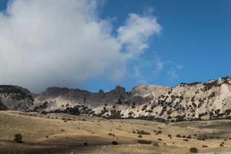 Quacella Mountain in the Madonie Park with clouds and blue skyの写真素材