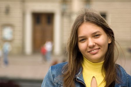 young girl in jeans jacket laughingの写真素材