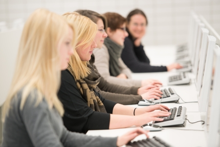 young women working with personal computers in office or in university