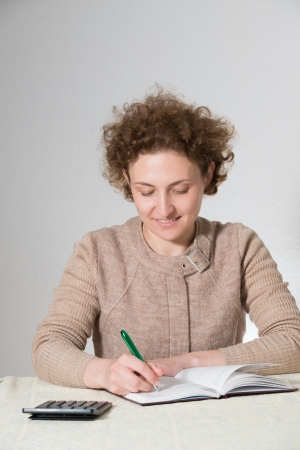young curly woman works as bookkeeper (accountant)の写真素材