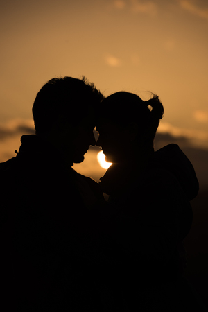 young couple kissing in sunsetの写真素材