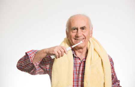 old senior man brushing his teethの写真素材