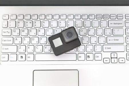 Action-camera on the background of a white laptop keyboard.の写真素材