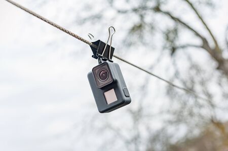Drying waterproof action camera on the clip, against the sky.の写真素材