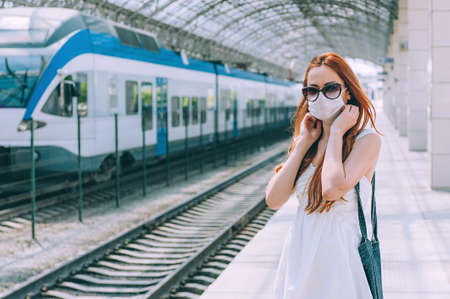 Woman with surgical mask face protection, walking airport train station work commute to hospitalの写真素材