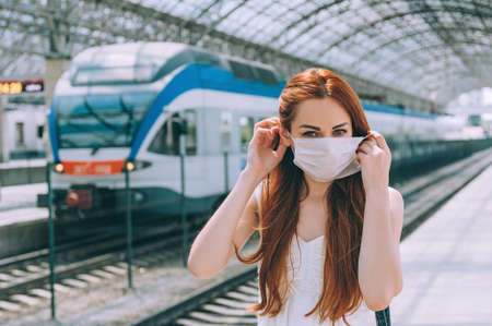 Woman with surgical mask face protection, walking airport train station work commute to hospitalの写真素材