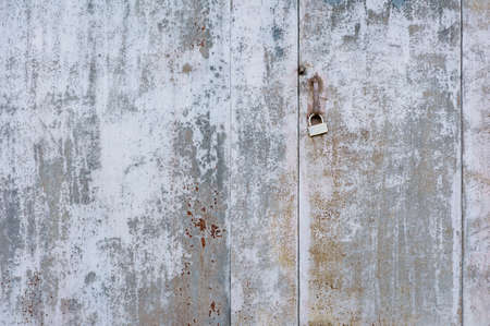 Texture, old metal gray wall and door, with paint-coated lock