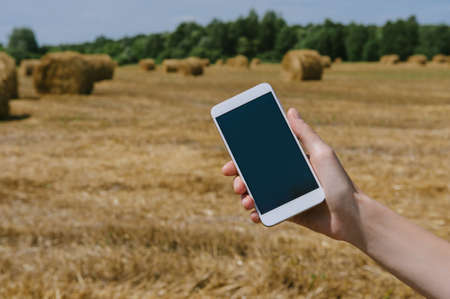 Close-up of a girl holding a smartphone mockupの写真素材