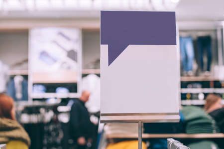 Closeup, Mock up of a white signboard on the background of a store with clothes