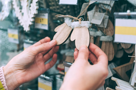 The girl in the store holds mittens in her hands New Year's decorative decorationsの写真素材