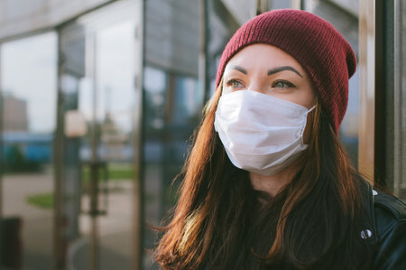 Close-up of a girl's face in a medical maskの写真素材