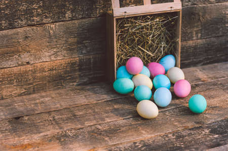 Close-up, a bunch of eggs with hay Against the background of a vintage boardの写真素材