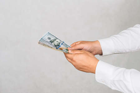 Close-up Money in the hands of a man. On a light background