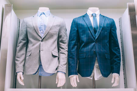 Close-up. Jacket shirt and tie are hanging on the shop windowの写真素材