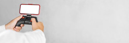 Banner, Gamepad with a smartphone mockup in the hands of a guy. On a light background