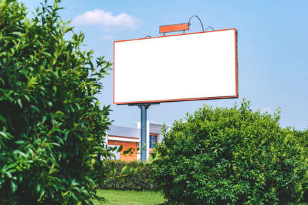 Blank billboard mockup with white screen. Against the backdrop of nature and blue sky. business concept. Copy space banner for advertisingの写真素材