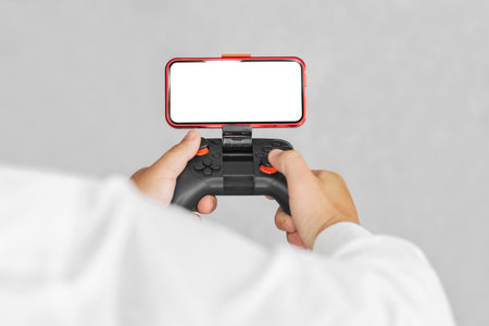 Gamepad with a smartphone mockup in the hands of a guy. On a light background