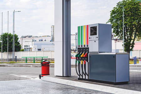 Gas station with colored fuel hoses. On the background of the road