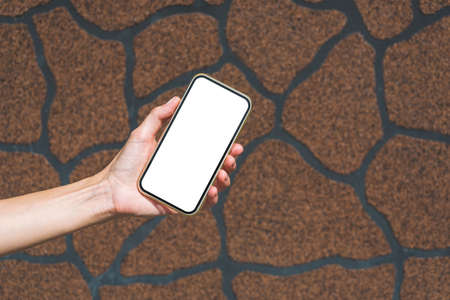 Smartphone mockup in girl's hand. On an abstract backgroundの写真素材