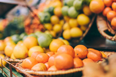 Close-up, tangerines on a background of lemon on the shelves in the supermarketの写真素材