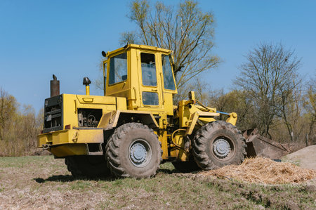 Yellow wheel loader excavator. Against the background of the fieldの写真素材