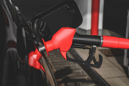 Close-up view, Pistol of gas station is inserted into the tank car for refuelの写真素材