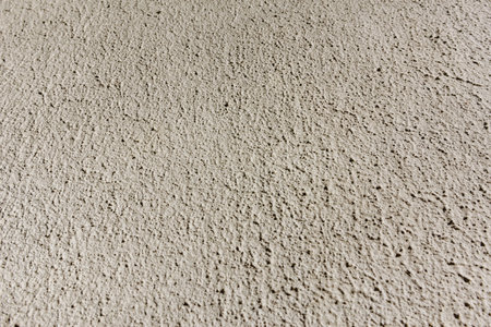 Close-up, background texture of a beige facade wall of a house made of decorative plaster. Abstract surfaceの写真素材