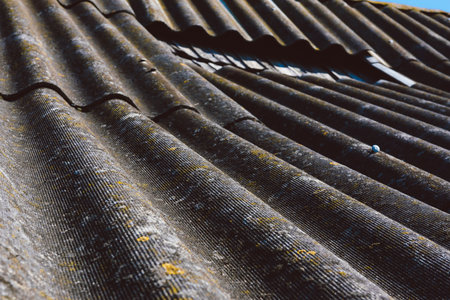 Close-up. Old slate roofing sheets. Gray texture of wavy weathered abandoned roof background.の写真素材