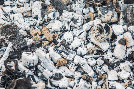 Close-up of a pile of actively smoldering coal on a dark backgroundの写真素材