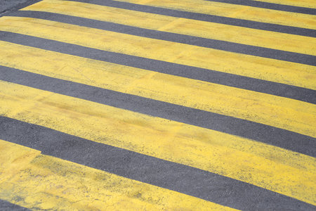 Old yellow pedestrian crossing on the asphalt. Road close-upの写真素材