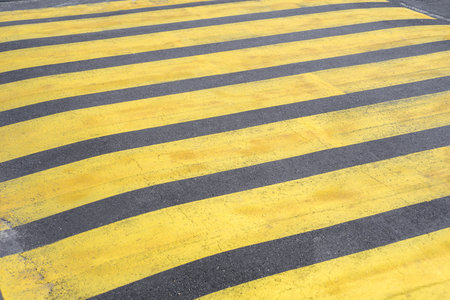 Old yellow pedestrian crossing on the asphalt. Road close-upの写真素材