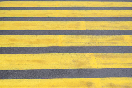 Old yellow pedestrian crossing on the asphalt. Road close-upの写真素材