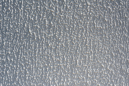 Close-up, background texture of a beige-white facade wall of a house made of decorative plaster. Abstract surfaceの写真素材