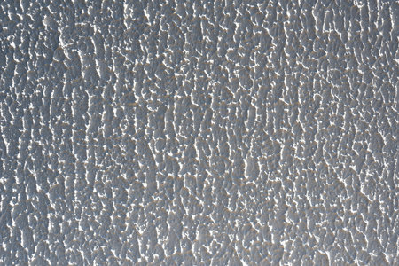 Close-up, background texture of a beige-white facade wall of a house made of decorative plaster. Abstract surfaceの写真素材