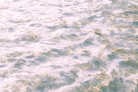 Close up, clear blue water, in the pool shines on a summer dayの写真素材