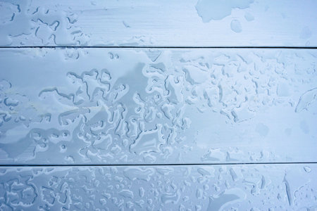 Close-up, background gray wet wooden tabletop with waterの写真素材
