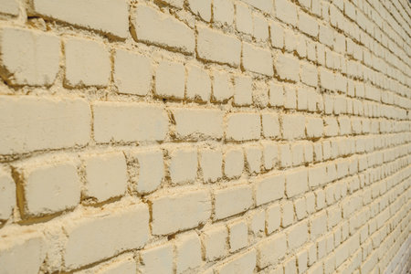 Closeup backgrounds texture of yellow beige painted retro brick wallの写真素材