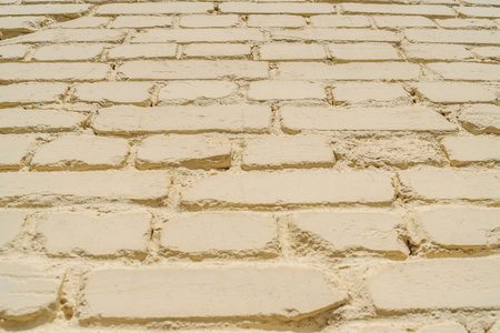 Closeup backgrounds texture of yellow beige painted retro brick wallの写真素材