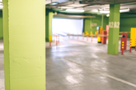 The background of an empty underground parking lot is green with a barrierの写真素材