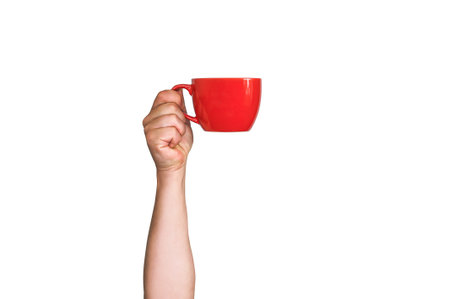Isolated red mug for coffee, tea in a man's hand. On a white backgroundの写真素材