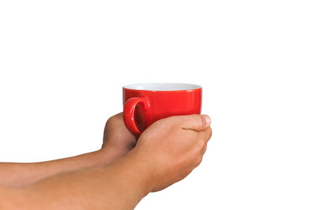 Close-up. Isolated red mug for coffee, tea in the hands of a man. On a white backgroundの写真素材