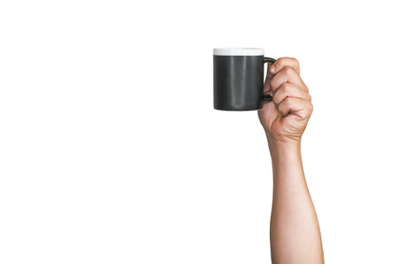 Isolated black mug for coffee, tea in a man's hand. On a white backgroundの写真素材